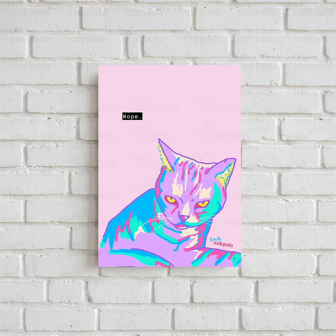 A vertical art print featuring a stylized cat in pink, purple, blue, and green tones on a light pink background, hanging on a white brick wall.
